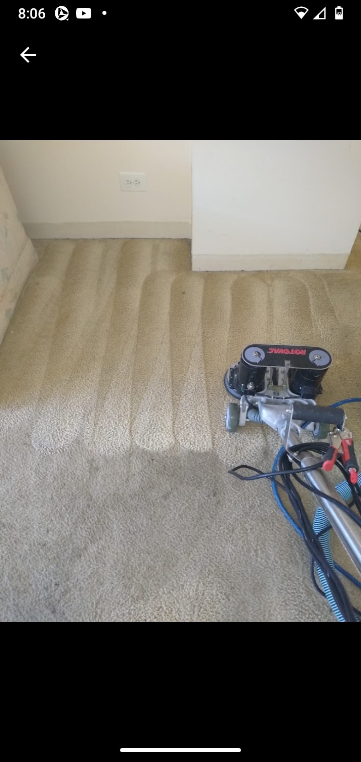 Rotovac machine working on a beige carpet with visible cleaning passes